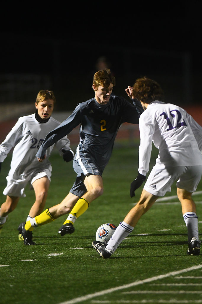 Aaron VanDyke tries to evade Hickman players during their playoff match